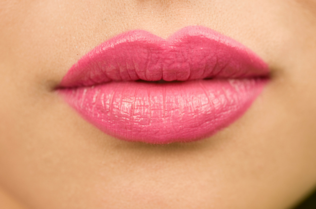 woman's voluptuous lips with pink lipstick